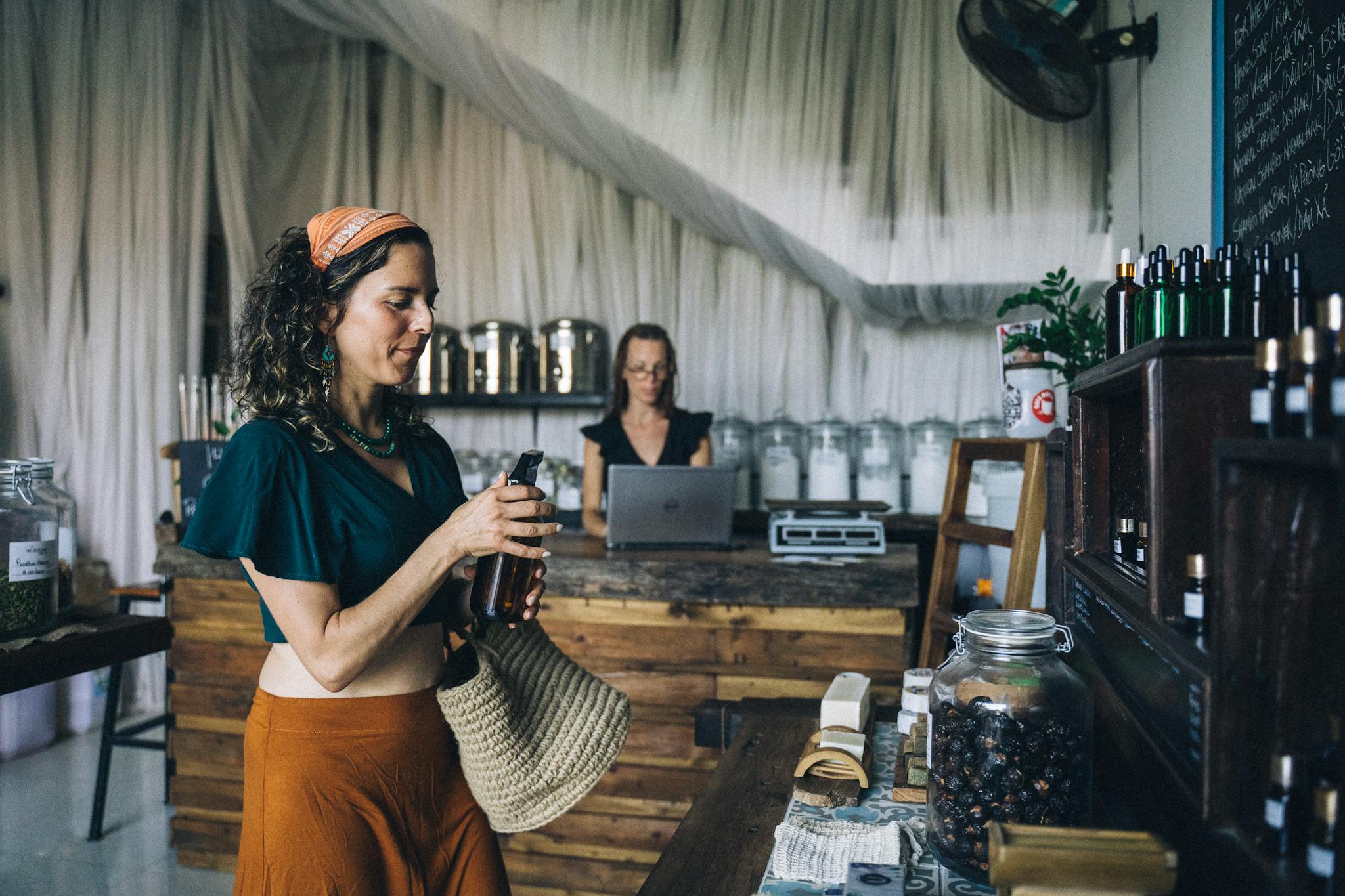 Woman shopping for organic products in eco-friendly store with rustic decor.
